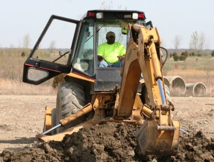 worker on machine construc